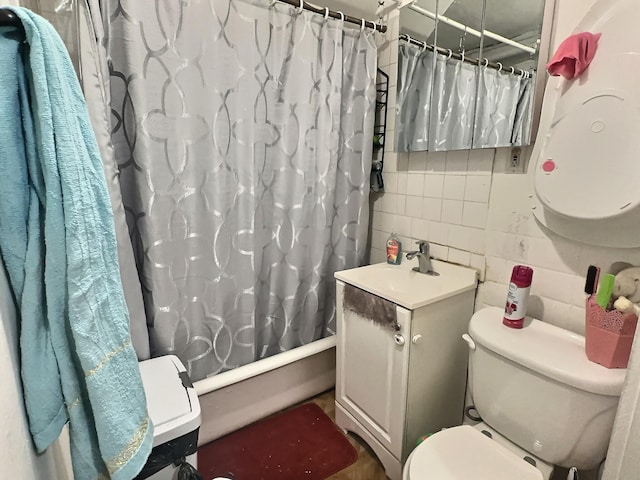 full bathroom with shower / bath combo, vanity, and toilet