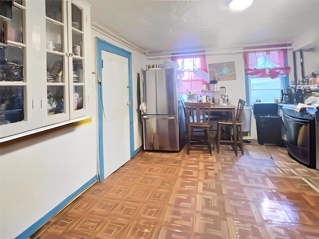 kitchen featuring white cabinets and stainless steel fridge