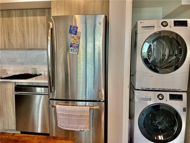 laundry area with stacked washer and clothes dryer