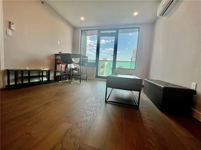 interior space with hardwood / wood-style floors and a wall unit AC