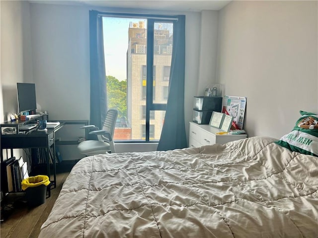 bedroom with hardwood / wood-style floors