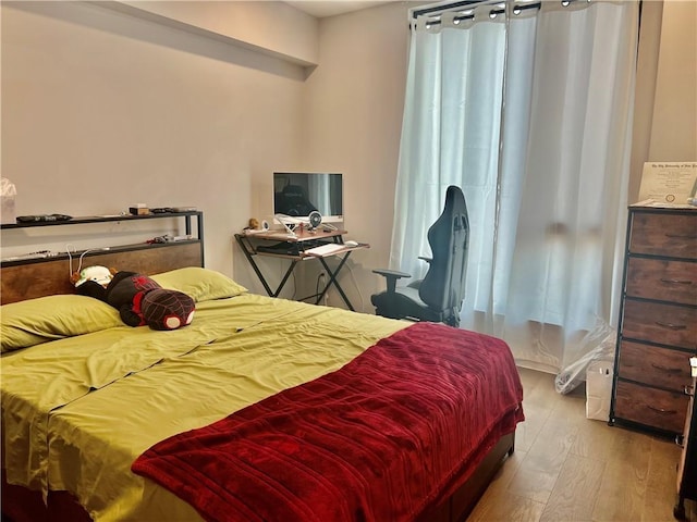 bedroom with light wood-type flooring