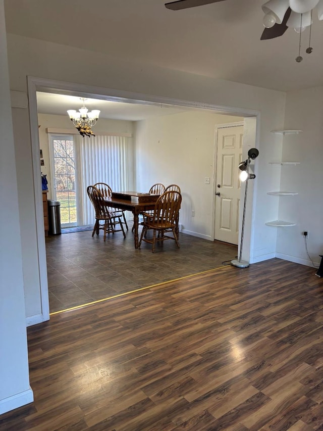 dining space featuring ceiling fan with notable chandelier and dark hardwood / wood-style floors