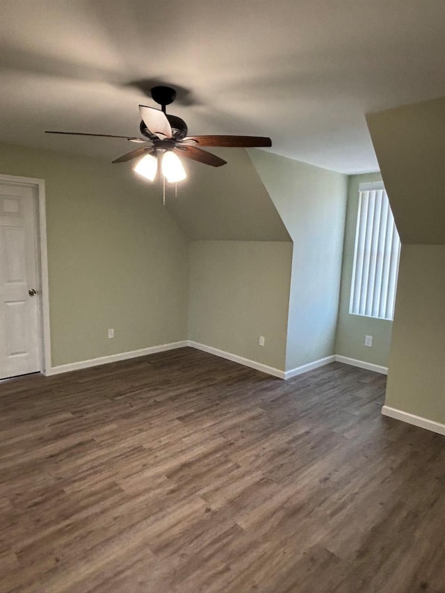 additional living space featuring ceiling fan, dark wood-type flooring, and vaulted ceiling