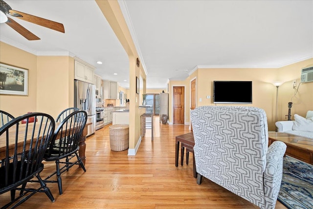 dining room with crown molding, ceiling fan, and light wood-type flooring