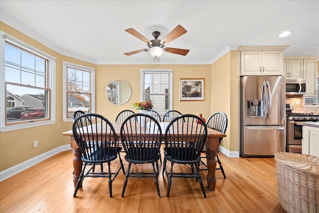 dining room with ceiling fan, light hardwood / wood-style floors, and crown molding