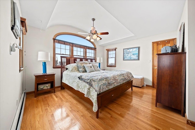 bedroom with ceiling fan, light wood-type flooring, and a baseboard radiator