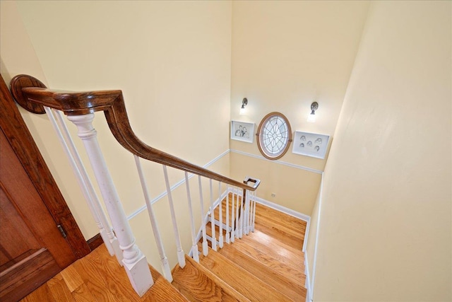 stairs featuring hardwood / wood-style flooring