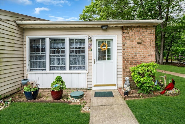 423 Woodbridge Unit D, Ridge, NY 11961 - view of exterior entry with a lawn and brick siding