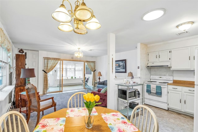 423 Woodbridge Unit D, Ridge, NY 11961 - dining space featuring a chandelier, baseboard heating, and light carpet