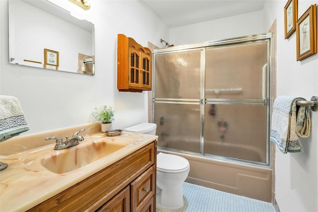 423 Woodbridge Unit D, Ridge, NY 11961 - bathroom with toilet, vanity, tile patterned floors, and bath / shower combo with glass door