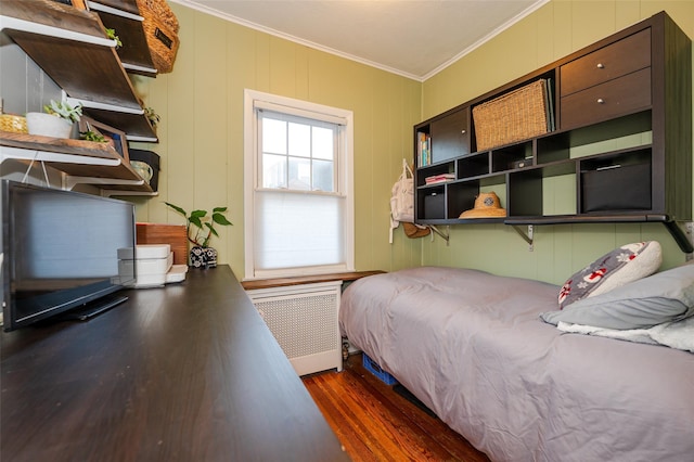 bedroom featuring radiator heating unit, dark hardwood / wood-style flooring, and crown molding