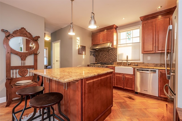 kitchen featuring decorative backsplash, appliances with stainless steel finishes, light parquet floors, sink, and hanging light fixtures