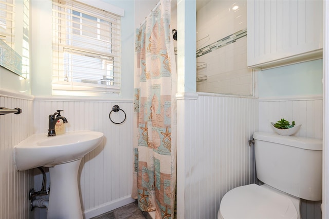 bathroom featuring curtained shower and toilet