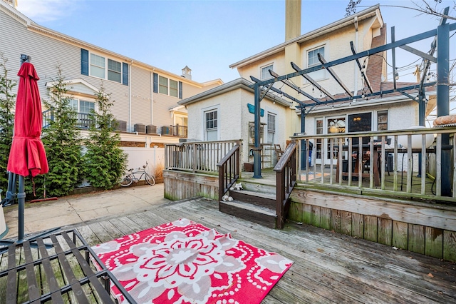 back of house with a pergola and a deck