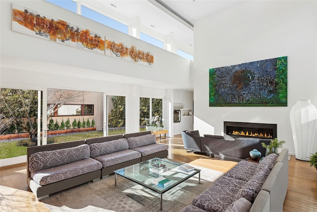 living room featuring wood-type flooring and a high ceiling