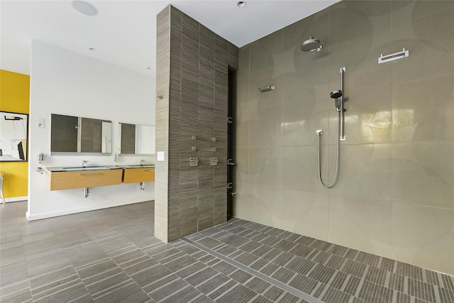 bathroom featuring a tile shower and vanity