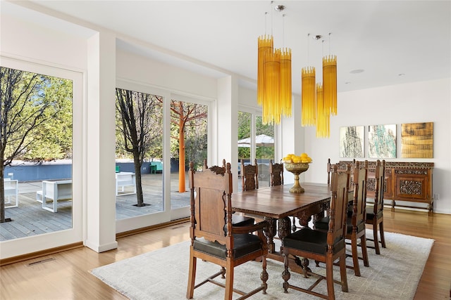 dining room featuring hardwood / wood-style flooring and a notable chandelier