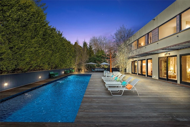 view of pool at dusk