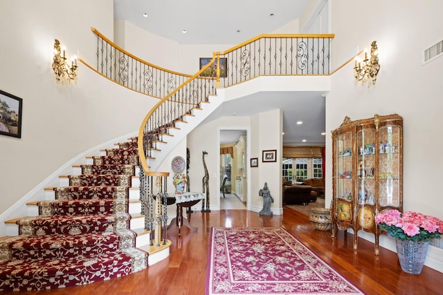 entryway featuring hardwood / wood-style floors and a high ceiling