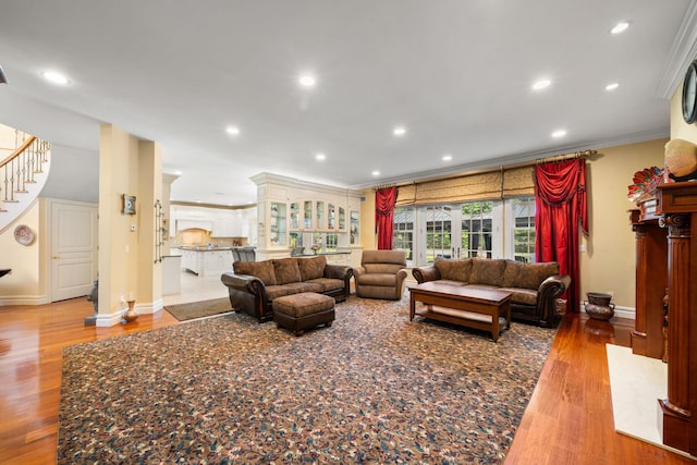 living room with light hardwood / wood-style flooring and ornamental molding