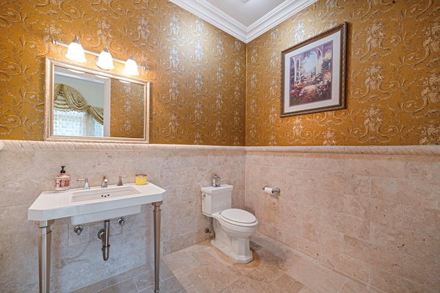 bathroom with toilet and crown molding