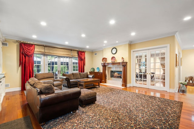 living room featuring french doors, crown molding, and wood-type flooring