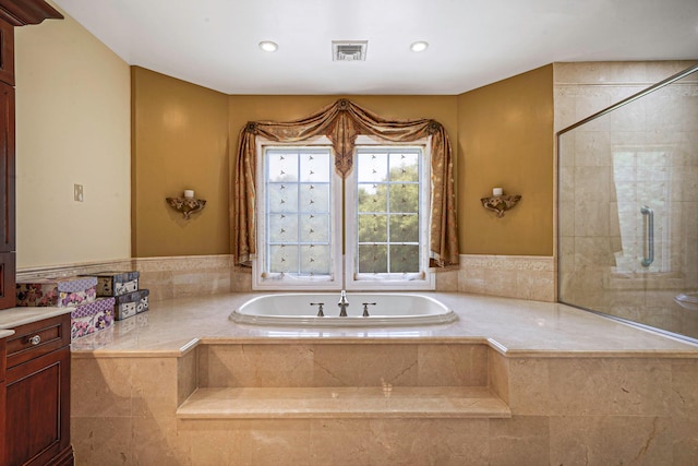 bathroom with plus walk in shower and vanity