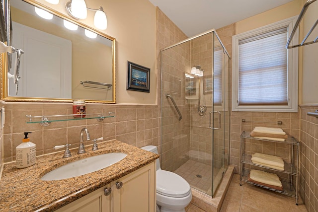 bathroom featuring walk in shower, tile patterned floors, toilet, vanity, and tile walls