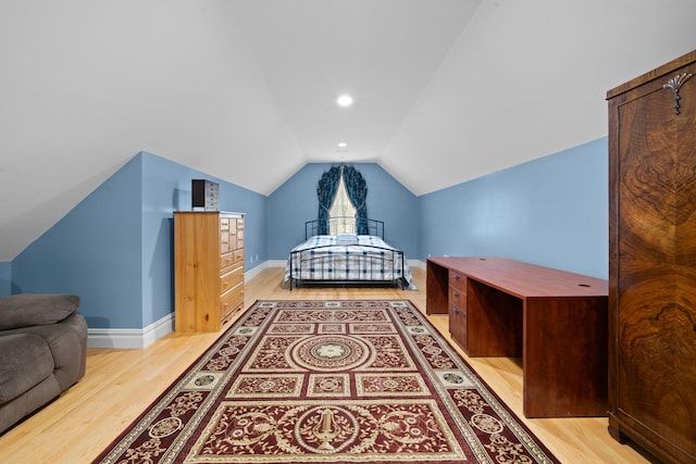 bedroom featuring light hardwood / wood-style flooring and vaulted ceiling