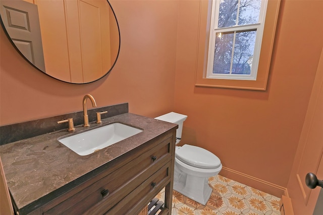 bathroom featuring tile patterned flooring, vanity, and toilet