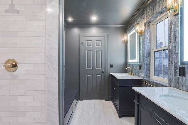 bathroom featuring tile patterned floors, crown molding, plenty of natural light, and vanity