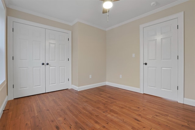 unfurnished bedroom featuring ceiling fan, wood-type flooring, and ornamental molding