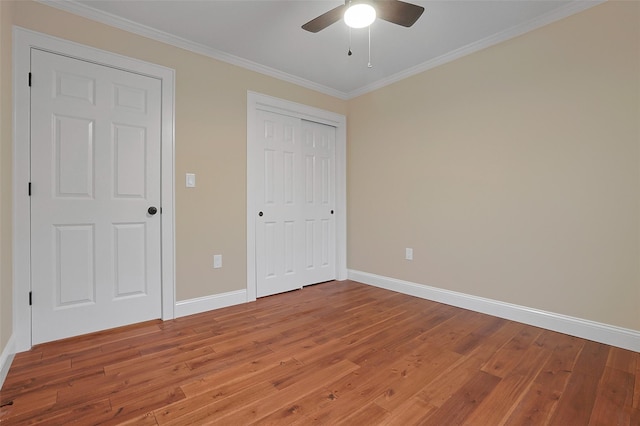 unfurnished bedroom with hardwood / wood-style floors, ceiling fan, and ornamental molding