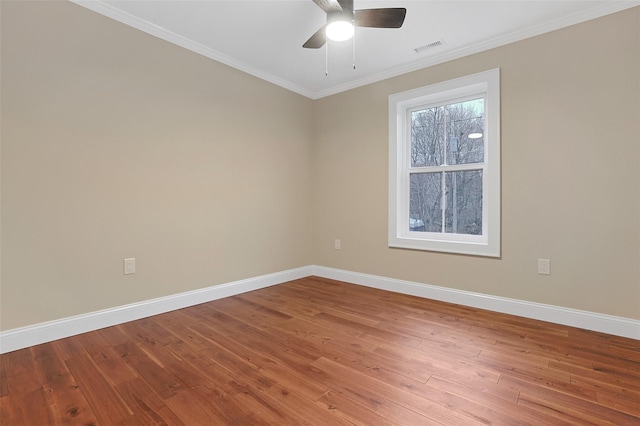 spare room featuring ceiling fan, hardwood / wood-style floors, and ornamental molding