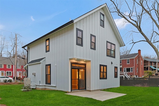 back of house featuring a lawn and a patio area