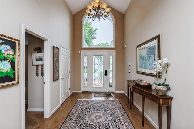 61 Redan Dr, Smithtown, NY 11787 - entryway with a chandelier, high vaulted ceiling, wood finished floors, and baseboards