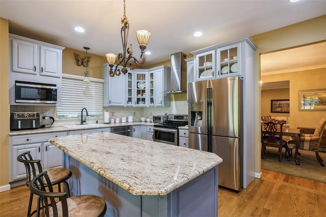 61 Redan Dr, Smithtown, NY 11787 - kitchen with wall chimney exhaust hood, stainless steel appliances, a sink, a breakfast bar area, and a chandelier