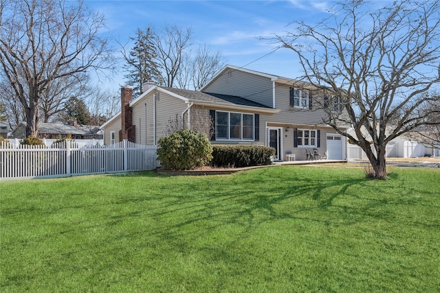 view of front of home with a garage and a front yard