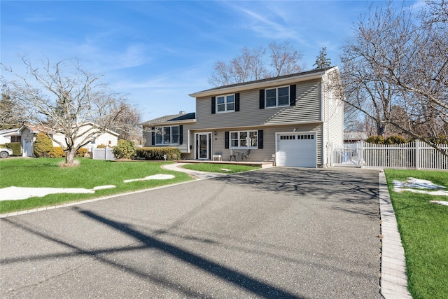 view of front facade featuring a garage and a front lawn