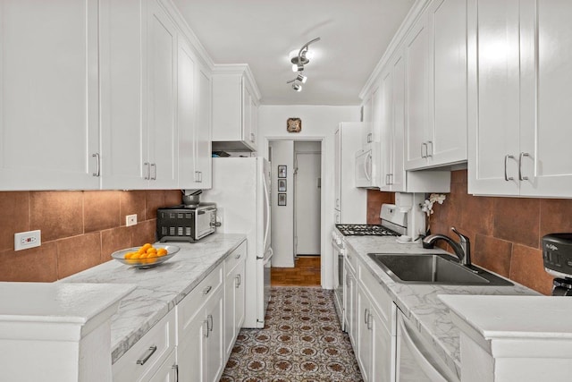5500 Fieldston Rd Unit 5Cc, Bronx, NY 10471 - kitchen featuring white appliances, a sink, white cabinetry, tasteful backsplash, and light stone countertops