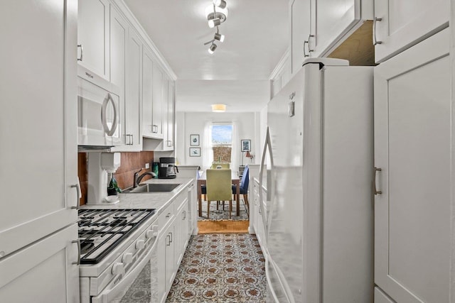 5500 Fieldston Rd Unit 5Cc, Bronx, NY 10471 - kitchen featuring white appliances, a sink, white cabinets, and light countertops