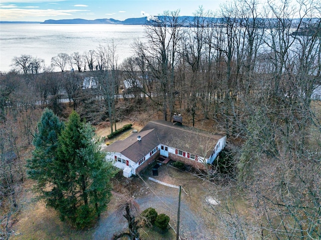 birds eye view of property with a water and mountain view