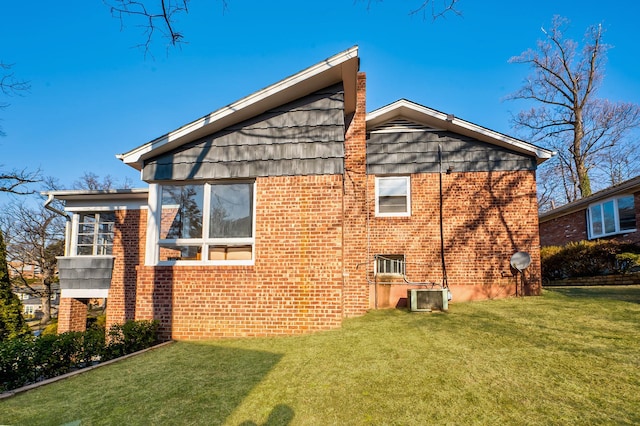 rear view of house with a lawn and central air condition unit