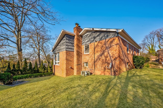 rear view of house featuring a lawn