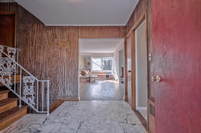 corridor featuring wooden walls