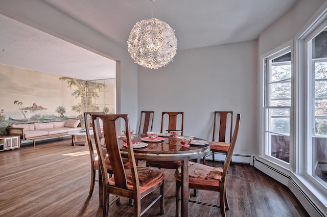 dining space featuring a baseboard heating unit, dark hardwood / wood-style flooring, and an inviting chandelier