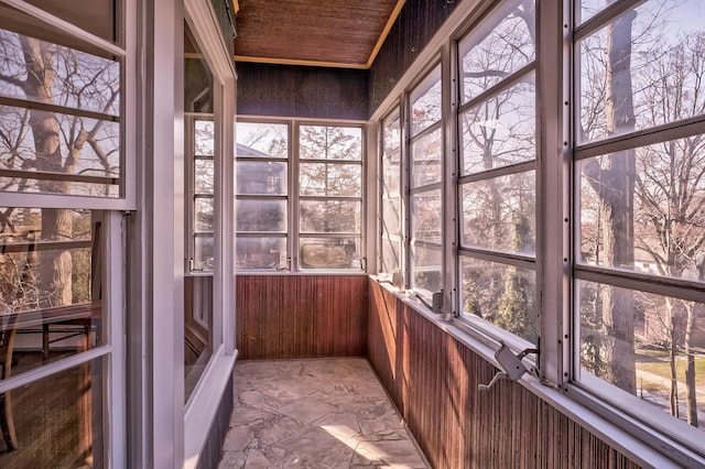 unfurnished sunroom featuring wooden ceiling