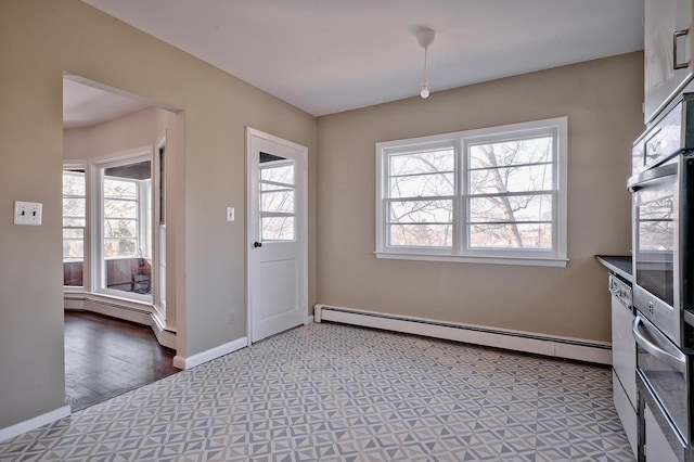 kitchen with a baseboard heating unit and oven