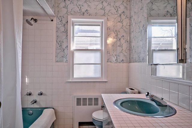 full bathroom featuring radiator, vanity, tile walls, toilet, and shower / tub combo with curtain